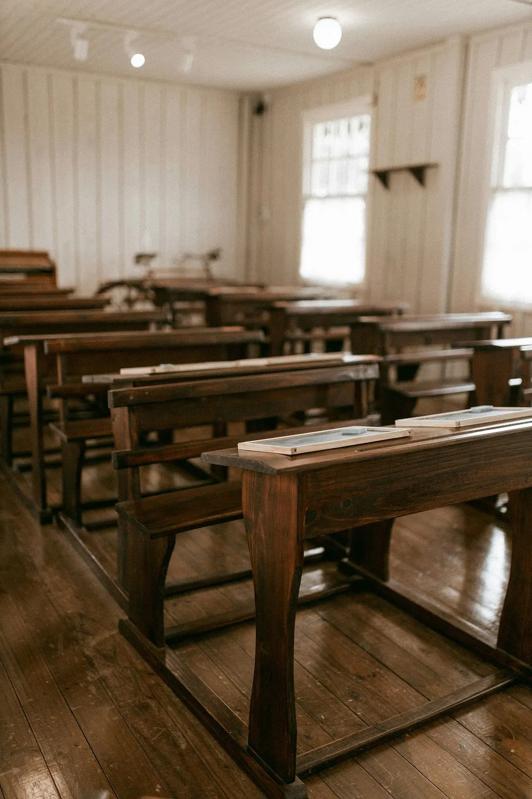 An old wooden desk in a vintage classroom setting