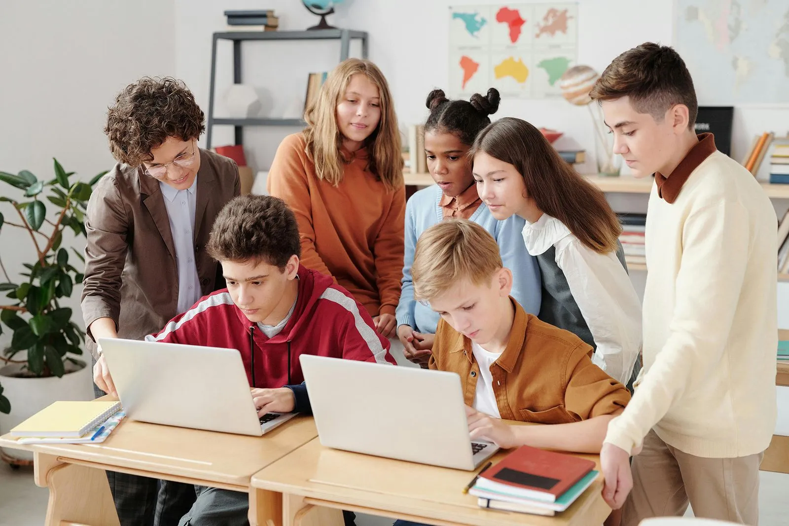 Students are working on laptops in a classroom